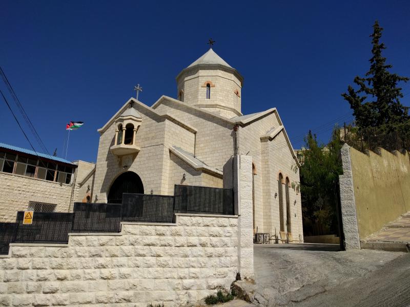Armenian church with pointy blue steeple in traditional style